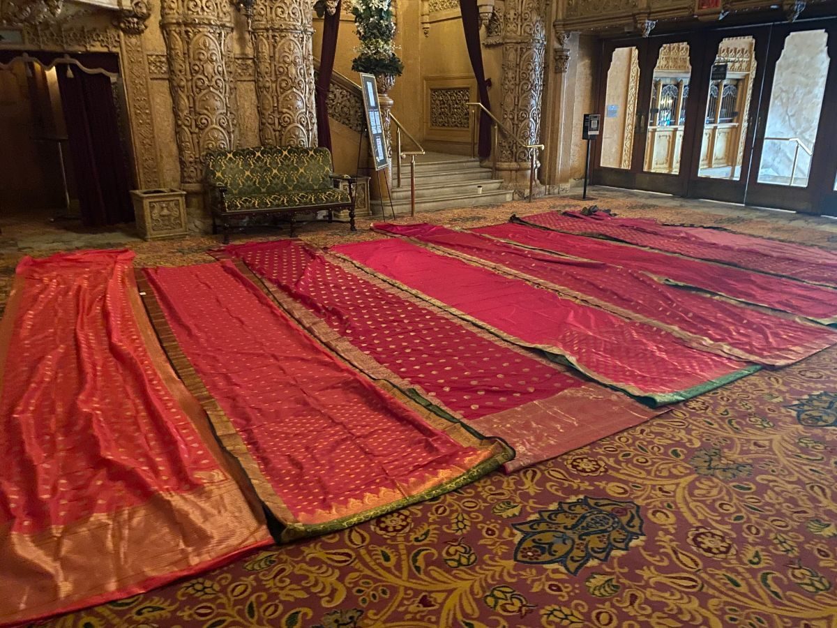 Saree fabric work for Moulin Rouge! The Musical laid out with the design team in the Regent Theatre foyer